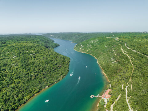 Aerial view of boats sailing along the Limski Fjord (Canal di Leme) in Sveti Lovrec, Istria, Croatia.