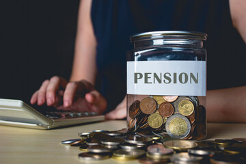 Woman calculate pension for retirement plan with jar of coin, Saving, fund , investment. - obrazy, fototapety, plakaty