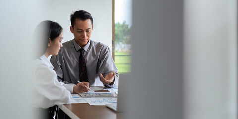 Asian business team meeting to analyze and discuss the situation on the financial report in the meeting room. Investment Consultant, Financial advisor and accounting concept