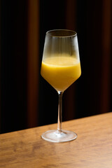 Classic cocktail glass with fresh grapefruit on wooden table