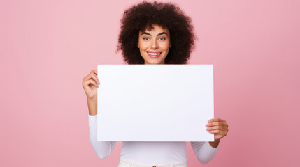 a handsome black african american woman holding a blank placard sign poster paper in his hands. empty space for editing and ads isolated on pastel background.