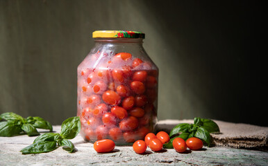 red and yellow cherry tomatoes in a jar for winter