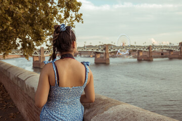 Woman on her back with the background of a bridge in Toulouse, France
