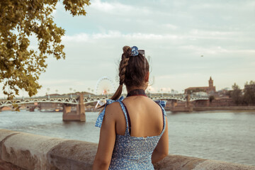 Woman on her back with the background of a bridge in Toulouse, France