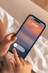 Smartphone in child hands with Incoming sister call on a screen.