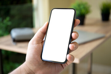 man hand holding phone with isolated screen background office