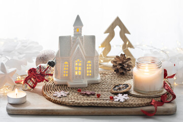 Christmas still life, christmas decorations, lights and little house.