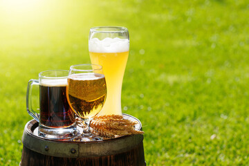Variety of beer glasses on rustic wooden barrel