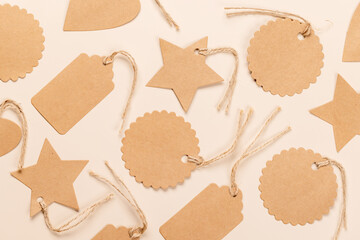 Various paper gift tags over beige background
