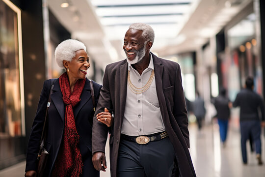 Happy senior african American couple man and woman shopping together and walking together in shopping mall.