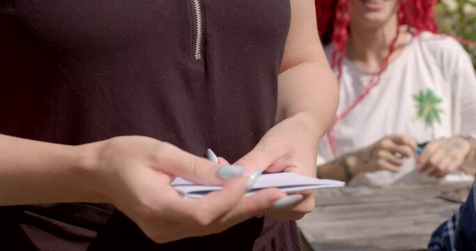 Close-up of the event host collecting questionnaires from participants at a speed dating event. Efficiently match participants based on their preferences and interests in collected questionnaires.