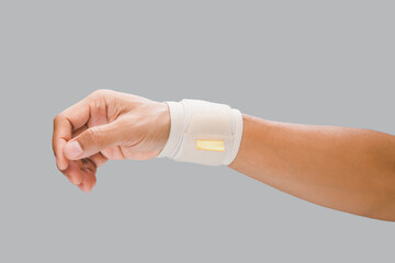 The man wears a wrist support. to alleviate wrist pain.