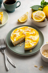Lemon cheesecake tart or pie, over grey background. Delicious dessert with fresh fruits.