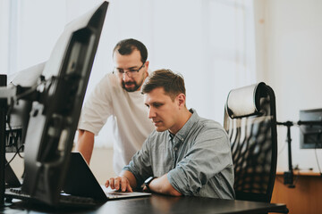 Portrait of two professional male programmers working on computer in diverse offices. Modern IT...
