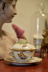 antique porcelain butter dish, antique butter dish, porcelain butter dish, antique objects on wooden sideboard