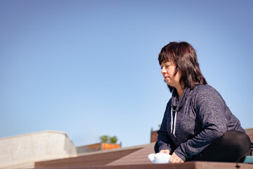 Yoga exercises. woman in sportswear in the park against the blue sky. High quality photo