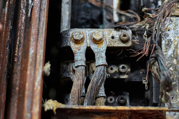 Close up of burned and oxidized heavy duty electrical terminals with wires connected.