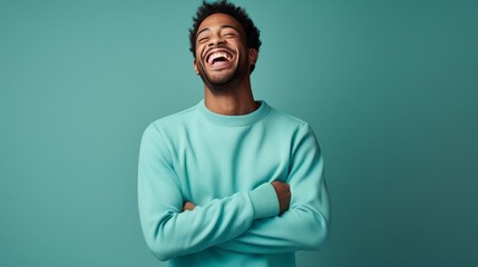 handsome young man, smiling and laughing, wearing vibrant sweater