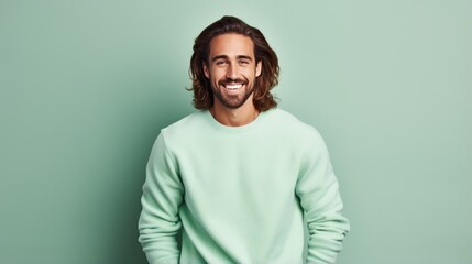 handsome young man, smiling and laughing, wearing vibrant sweater