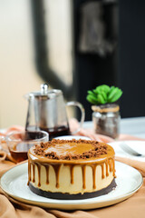 Salted Caramel Blondie cake include chocolate cream, sugar with fork, cup of coffee and pot served on board isolated on napkin side view of cafe food