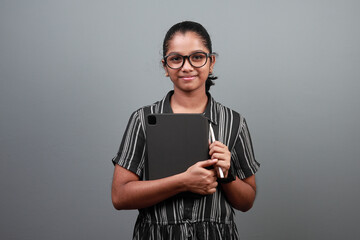 Portrait of a happy girl of Indian ethnicity with a tablet phone in hand