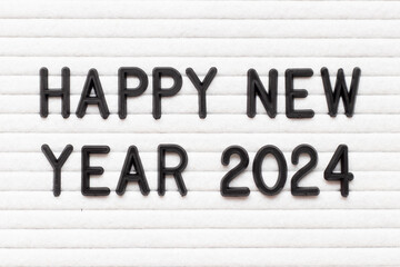 Black color letter in word happy new year 2023 on white felt board background