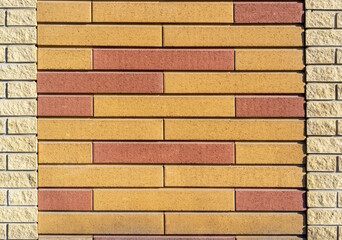 Decorative brick wall, yellow-burgundy color