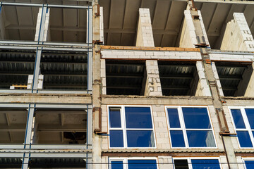 Fototapeta premium glazing with double-glazed windows construction of a high-rise building, view from bottom to top