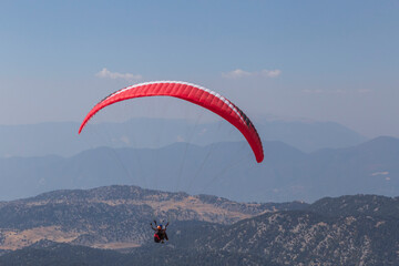 paraglider flying in mountains in Turkey