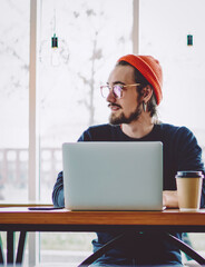 front view of caucasian freelancer sitting indoors