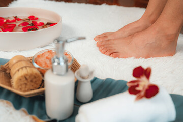 Woman indulges in blissful foot massage at luxurious spa salon while masseur give reflexology...