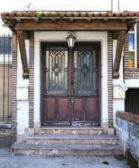 Old wooden door with white wrought details
