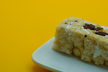 Chinese traditional dessert - Caramel treats, Sachima. yellow background