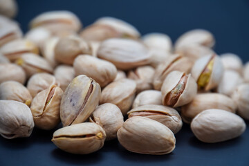 The pistachios on black background. The pistachio background.