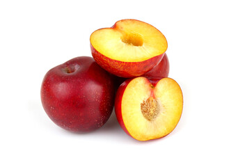 Naklejka na ściany i meble Whole and halved ripe Asian plums isolated on white background.