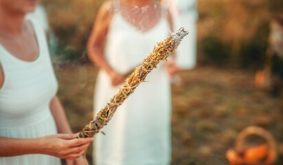 incense in a woman hand, ceremony space. - obrazy, fototapety, plakaty