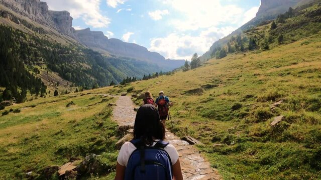 Hikers walking down trail in Ordesa natural park, Spain