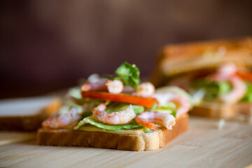 sandwich with lettuce and shrimp.