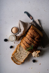 Fresh Sliced Homemade Wholegrain Wheat Bread whit olive oil on white rustic background. Artisan Sourdough