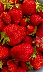 Fresh, ripe strawberries with vibrant red color and green leaves, showcasing a close-up of delicious, organic summer fruits perfect for healthy eating, farming, and natural food photography