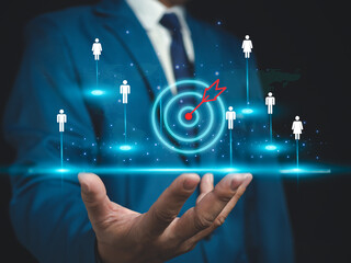 Businessman shows dart board in selecting business target group, target customers, buyers, customer behavior concept, marketing plan and strategy, personal marketing, customer centric strategy.