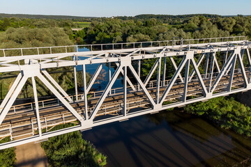 View of the structure of a metal railway bridge across the river