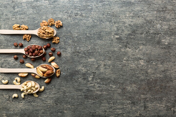 mixed nuts in white wooden spoon. Mix of various nuts on colored background. pistachios, cashews, walnuts, hazelnuts, peanuts and brazil nuts