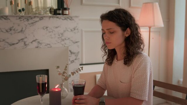 Anticipation and Disappointment: Young Woman Waiting for a Date in a Restaurant, Glancing at the Clock - Relationship Concept, Romantic Encounter, and Emotional Moments.  Partner does not come.