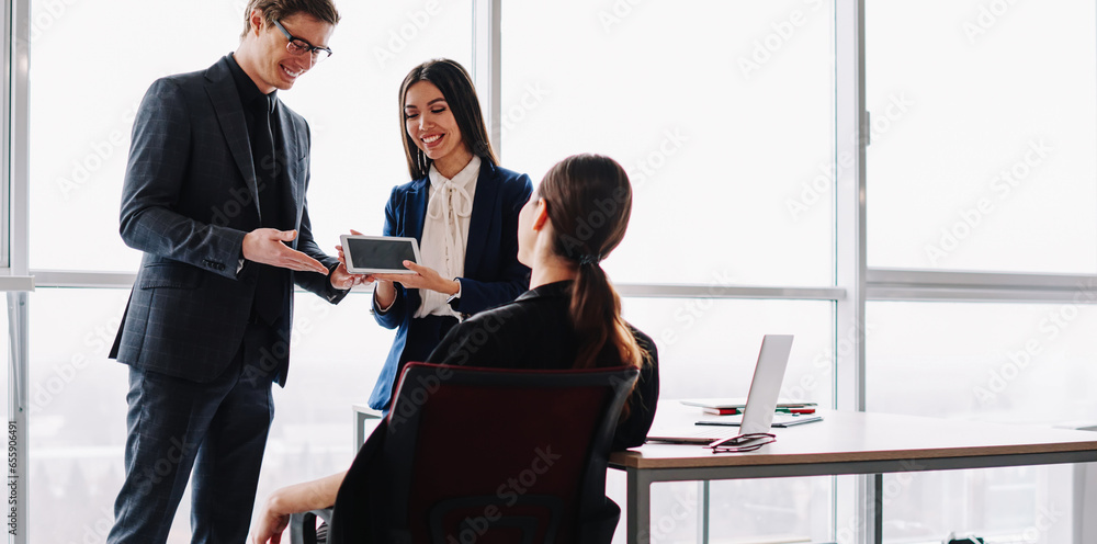 Poster smiling in formal wear traders introducing touchpad for online communication