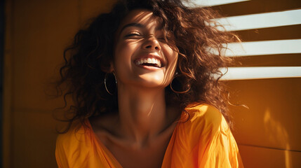 portrait of a brunette, ethnically ambiguous model laughing, warm yellow accents