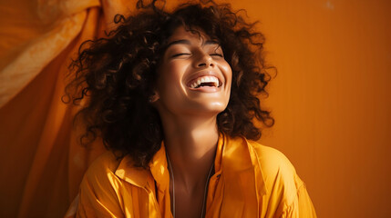 portrait of a brunette, ethnically ambiguous model laughing, warm yellow accents