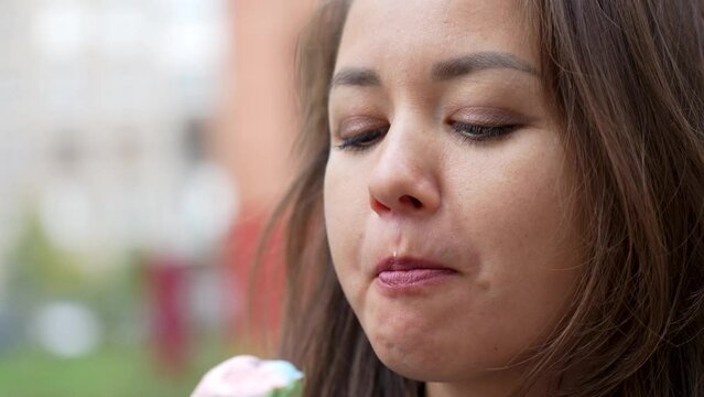 Young woman enjoys a delicious ice cream cone, outdoors