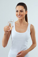 Beautiful woman  holding water glass. Drink water. Girl with glass of water. Diet concept
