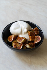 Fig with Burrata Cheese served in Plate.